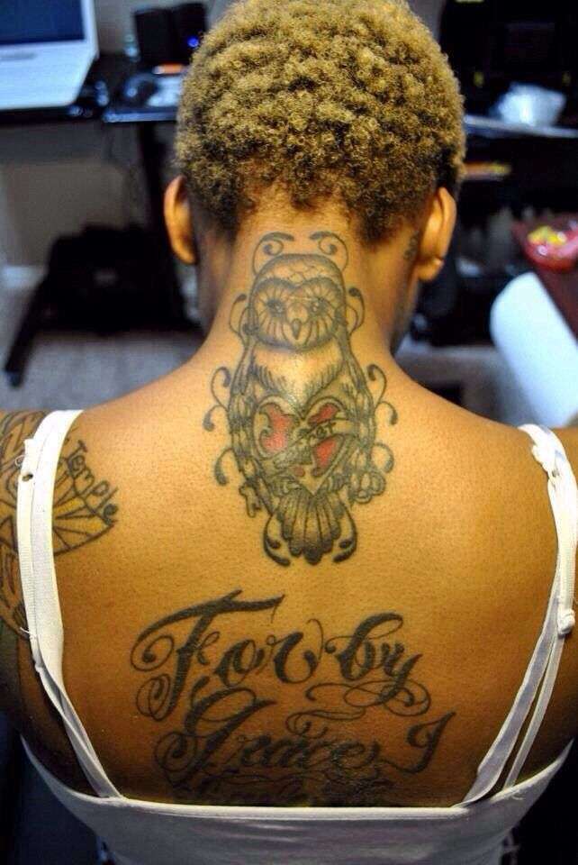 Brown skin black girl, back tattoo red ink